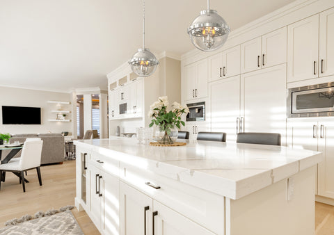 two globe pendants in brushed nickel hanging above the kitchen island