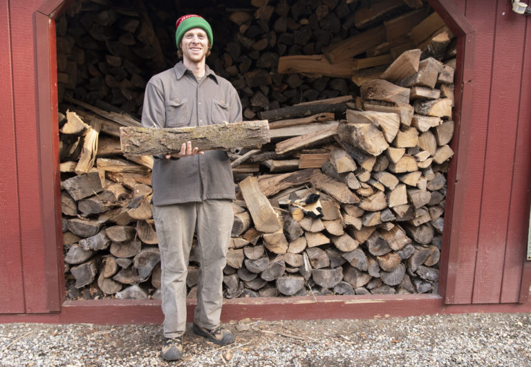 VWS land steward Jake Checani stands in front of wood shed