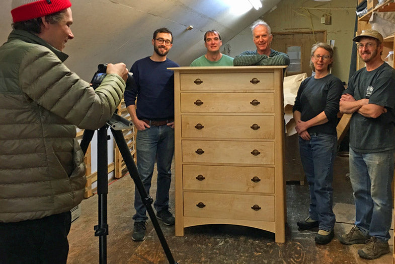 Robin Chase and his team at Maple Corner Woodworks in Calais, Vermont stands proudly in front of a Cherry Moon Chest of Drawers