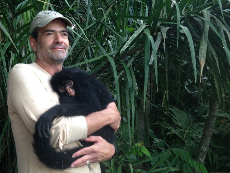Diego caring for an orphaned spider monkey | Conservation through ecotourism