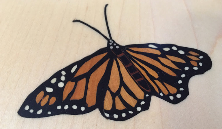 Inlaid monarch butterfly on maple end table