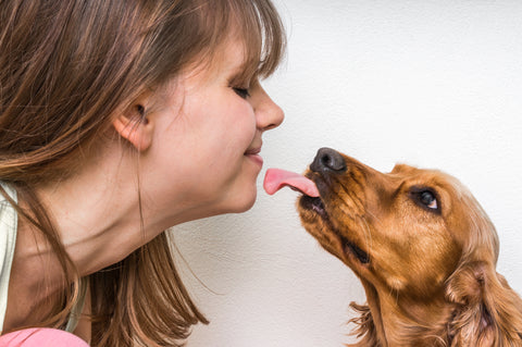 Dog licking a woman’s face