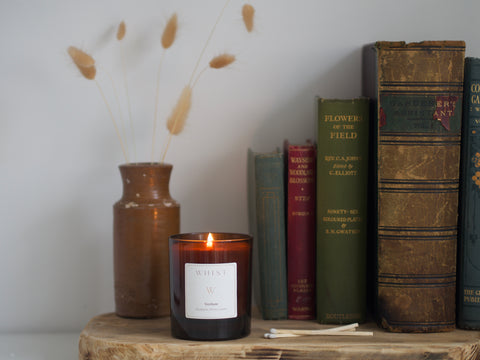 vintage books with an amber Whist candle