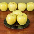 Yellow Golden Delicious Apple on table and plate