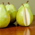 Hood Pear sitting on table desk cut open