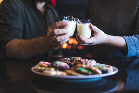 two people toasting with eggnog