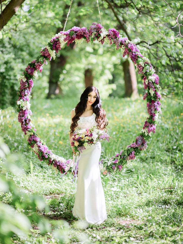 beautiful circular backdrop with purple and white lilacs for outdoor wedding ceremony