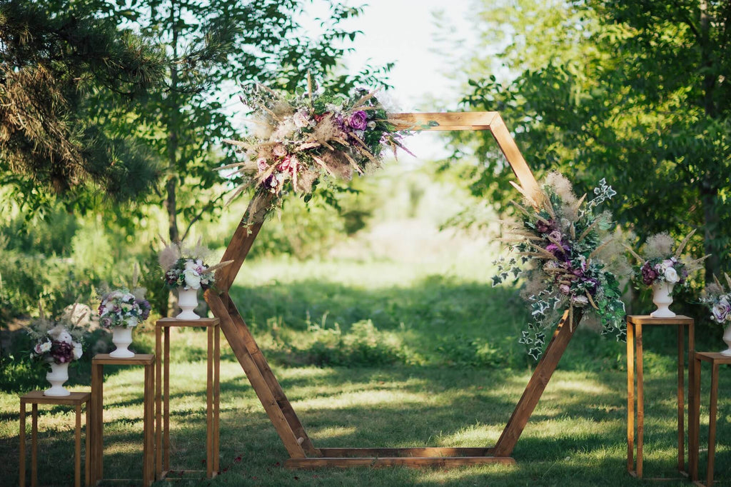 wooden hexagon wedding ceremony backdrop with flowers