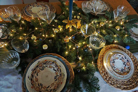 vintage mismatched plates used on a christmas table setting