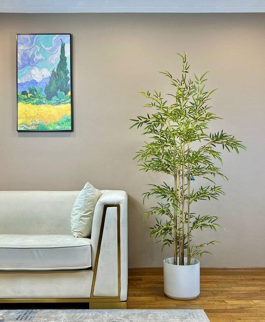 An Artificial Bamboo Tree in a pot placed in a room.