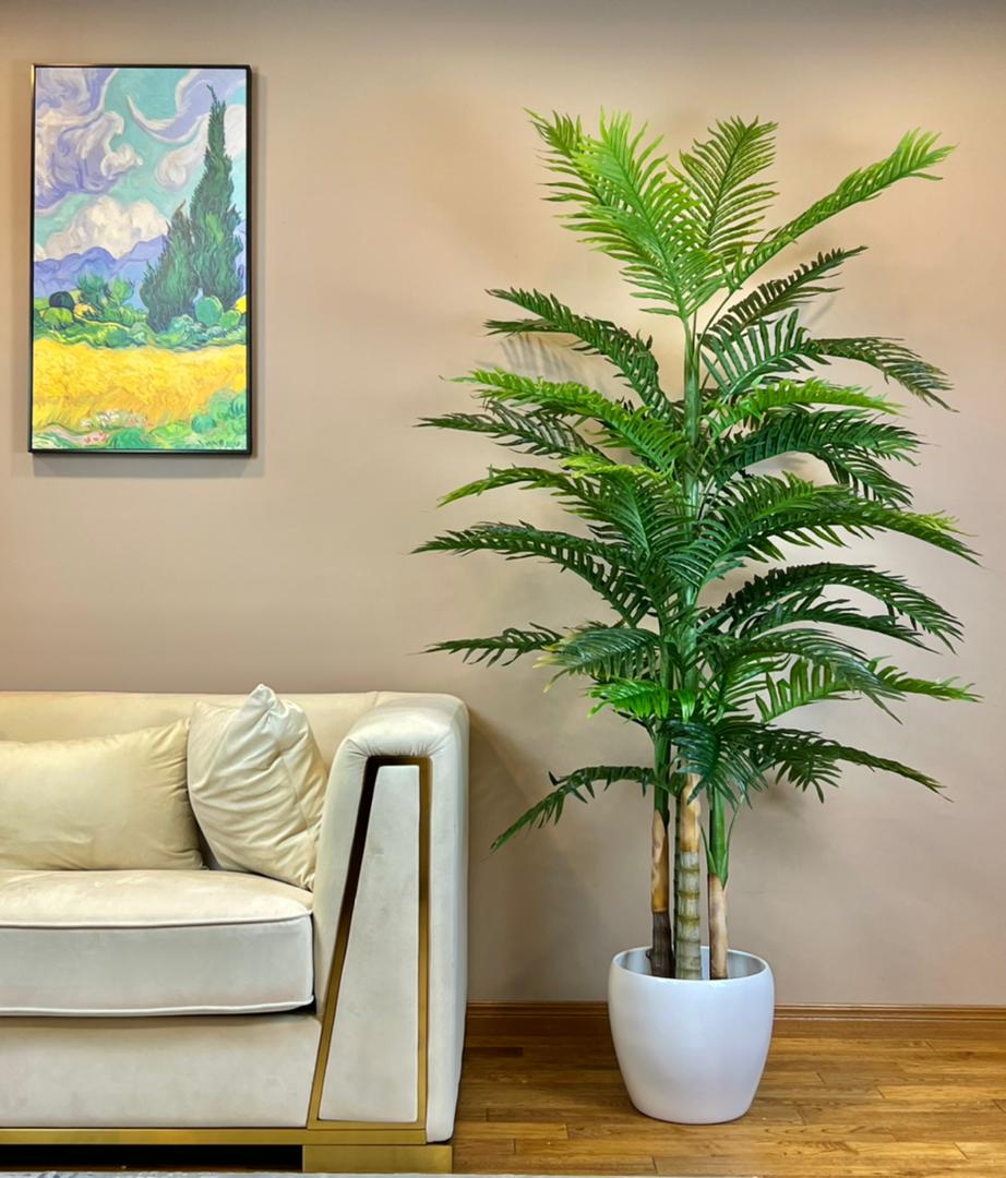 An Artificial Palm Tree in a white pot.
