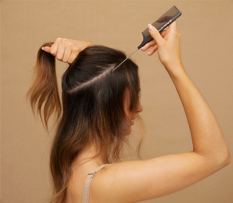 woman parting hair with tailcomb