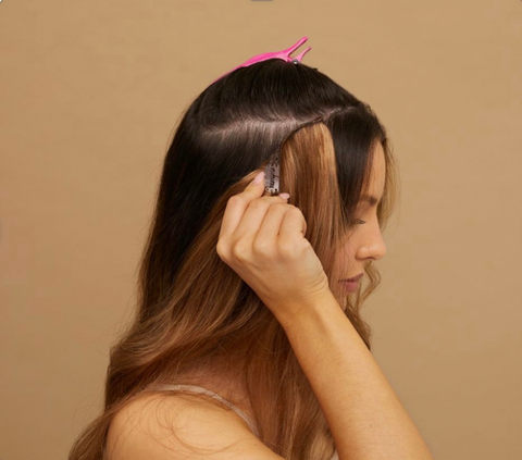 woman using clip in extensions