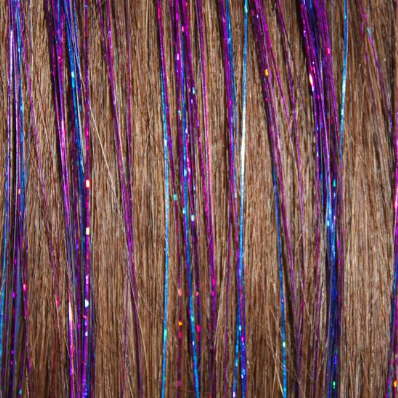 purple hair tinsels sparkling in brown hair