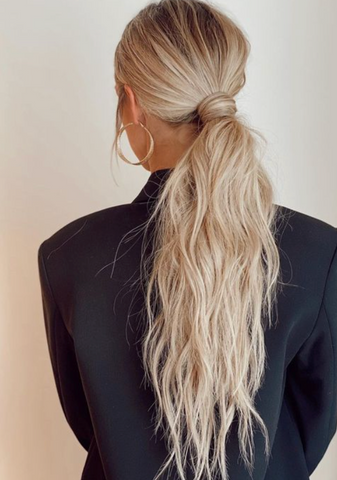 Blonde woman with wavy ponytail