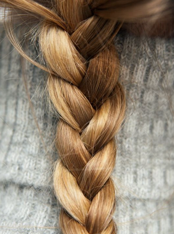 Blonde hair plaited into loose plait