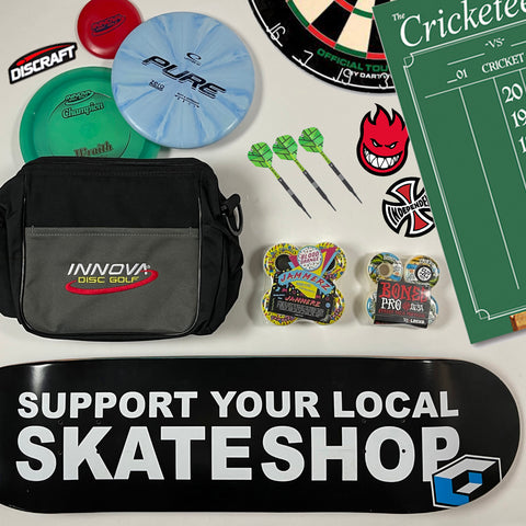 Flat Lay of Skateboards, Darts, & Disc Golf Accessories