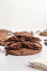 A stack of 3 Vegan Espresso Martini Cookies with a bite taken out of them.