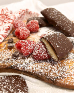 Cookie Butter Crunch cookies served with raspberries.