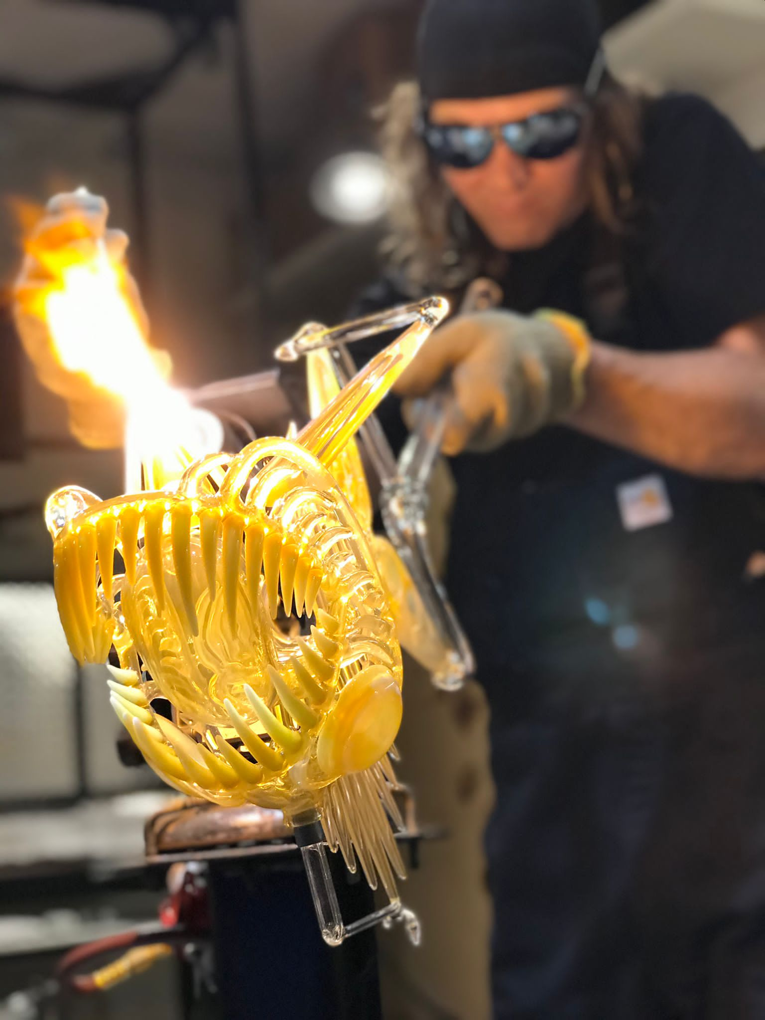 BUCK GLASS - Ryan "Buck" Harris blowing glass and sculpting his signature fish design on the torch.