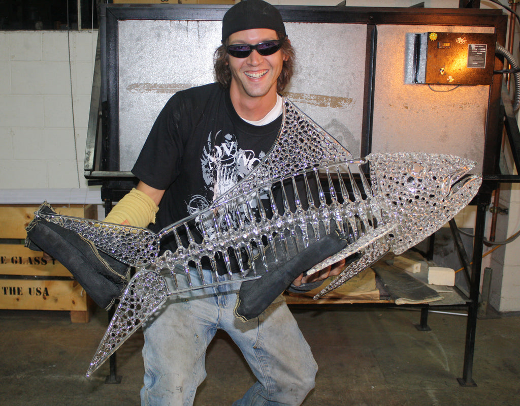 BUCK GLASS - Ryan "BUCK" Harris holding up his large glass art fish sculpture.