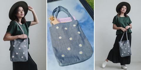 Organic denim tote bag with daisy patches stitched on the front