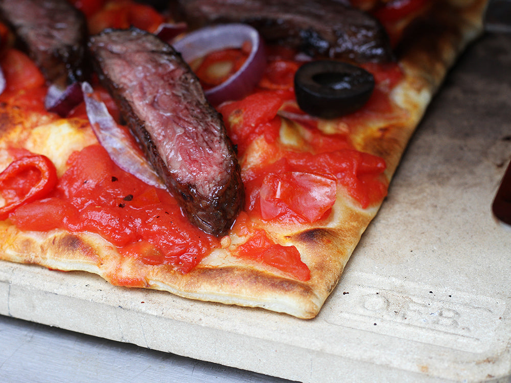 steak pizza on the pizza stone