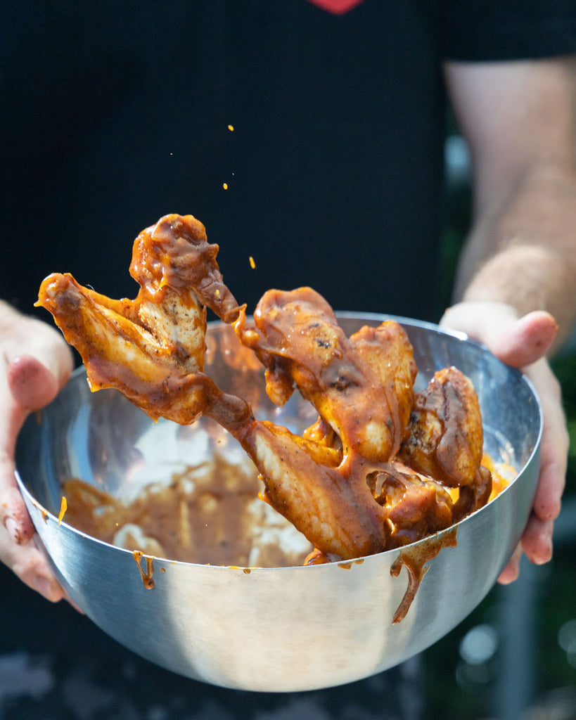 Chicken wings tossed in a bowl