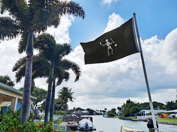Pirate flag flying in the tropical sun on a dock