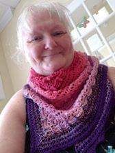 Lost in Time shawl crochet pattern made with Scheepjes Whirl Colour Turkish Delight at Artisanthropy.ca by Vickie, shown wearing her creation