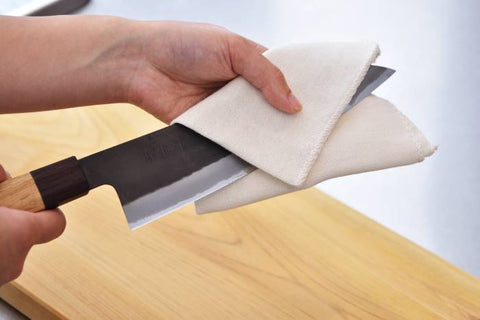 wiping a knife with a cloth