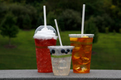 three sizes of our PLA compostable cups two with flat lids and one with a dome lid