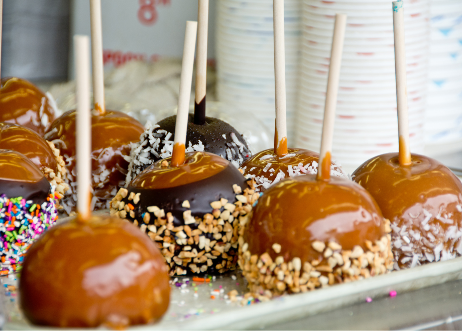 Caramel apples coated in chopped nuts