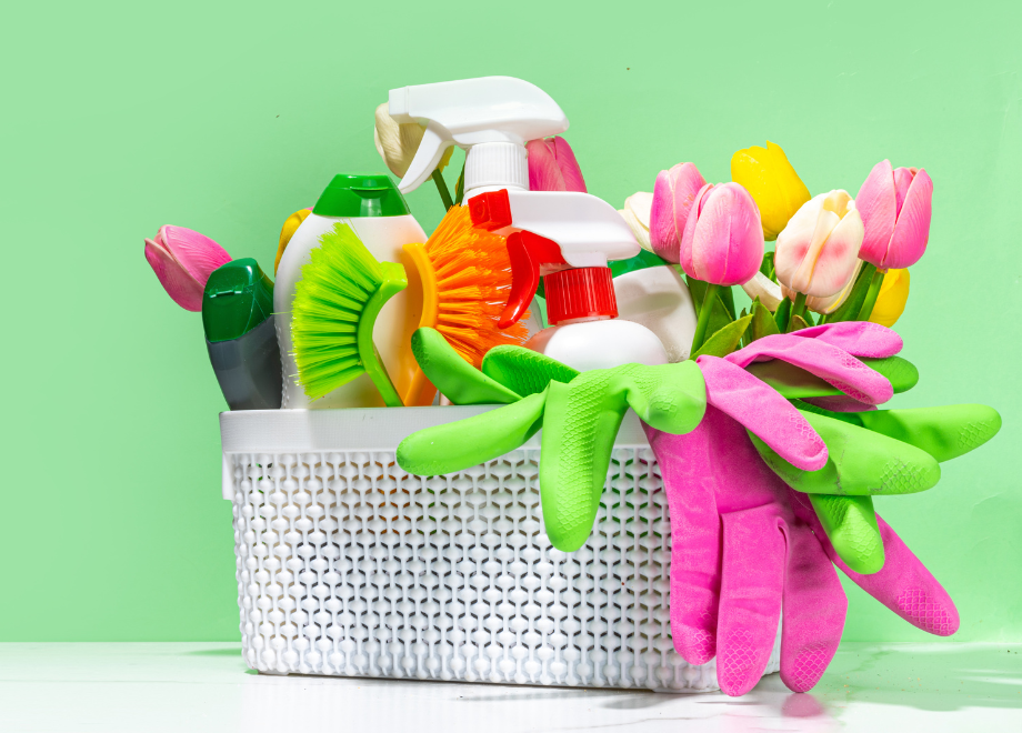 white plastic basket holds cleaning products, rubber gloves, and scrub brushes