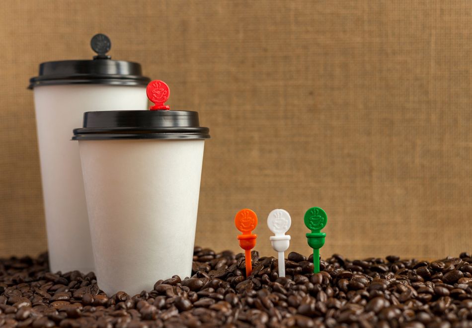 cocoa beans with coffee cup lid plugs standing in them