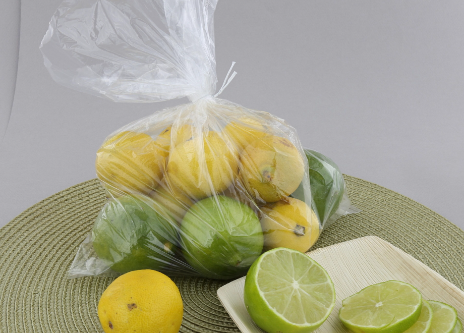 disposable clear bag filled with limes and lemons