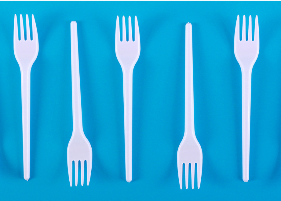 white plastic forks on a blue background