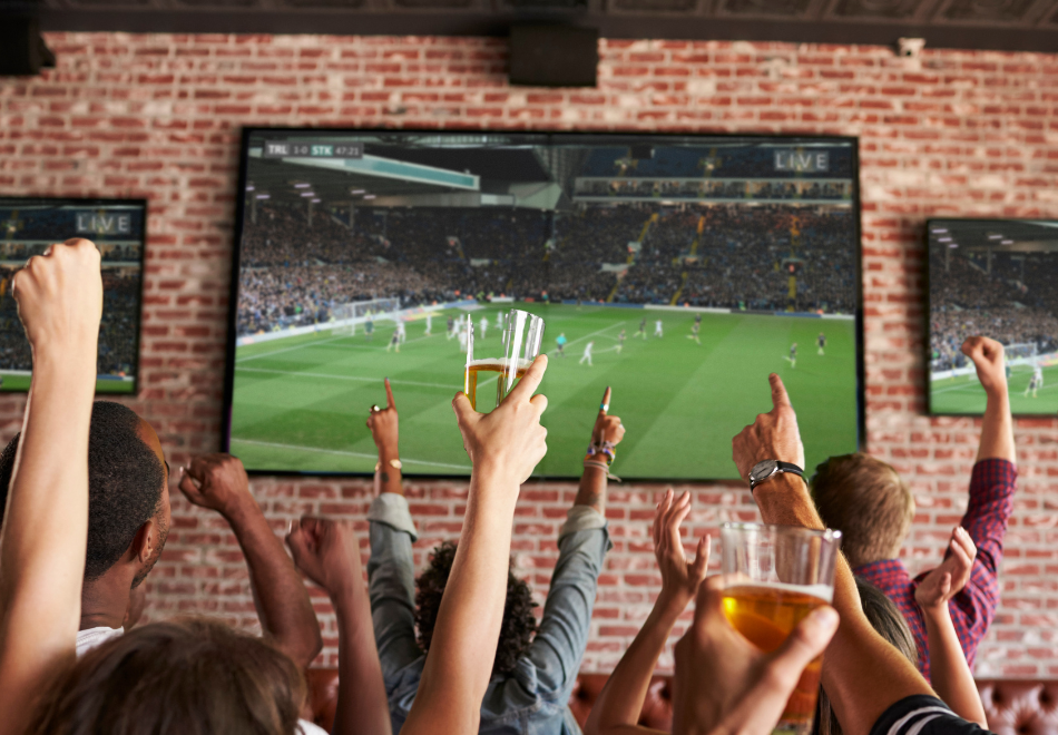 people at a sports bar watching a soccer game