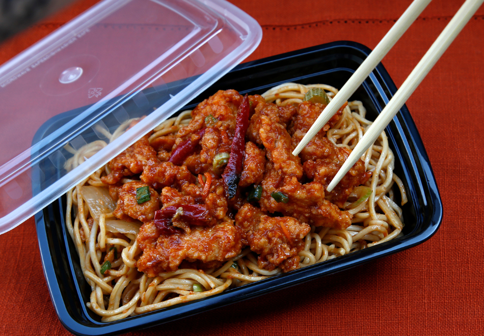 spaghetti in a black takeout container