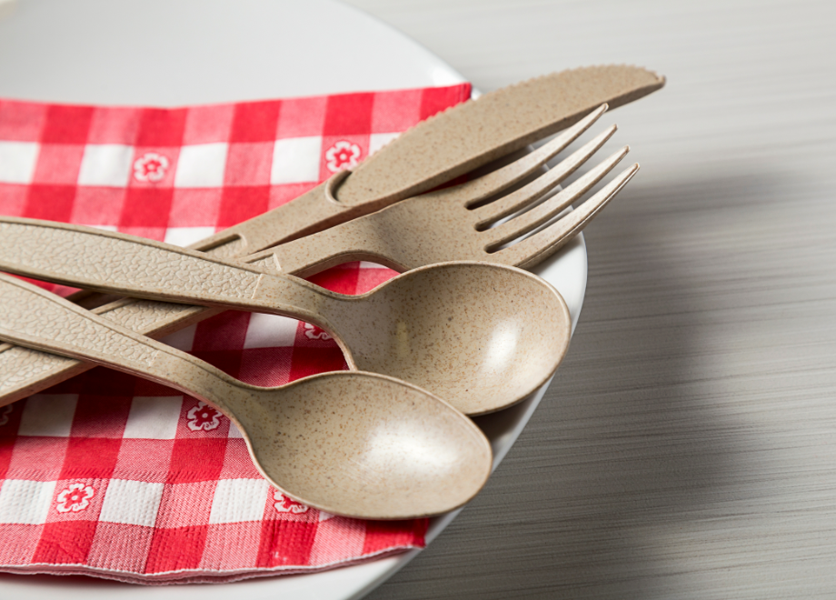 wheat cutlery on top of red gingham napkin