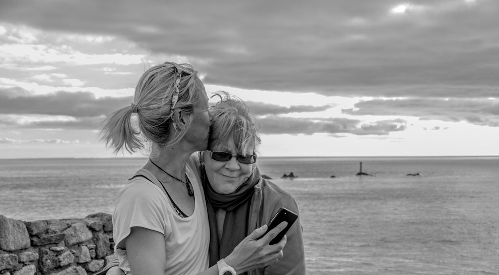 Yvie is hugging her mum and kissing her mum' on the head whilst at the finish of the LEJOGLE adventure