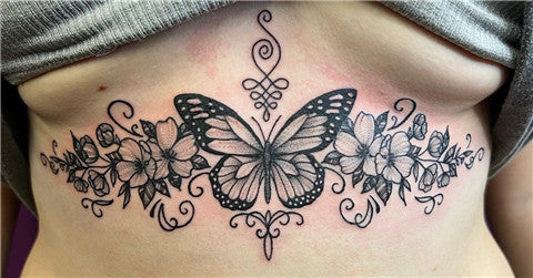 Floral butterfly tattoo on sternum