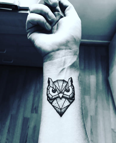 Geometricblackwork style owl tattoo on the left inner