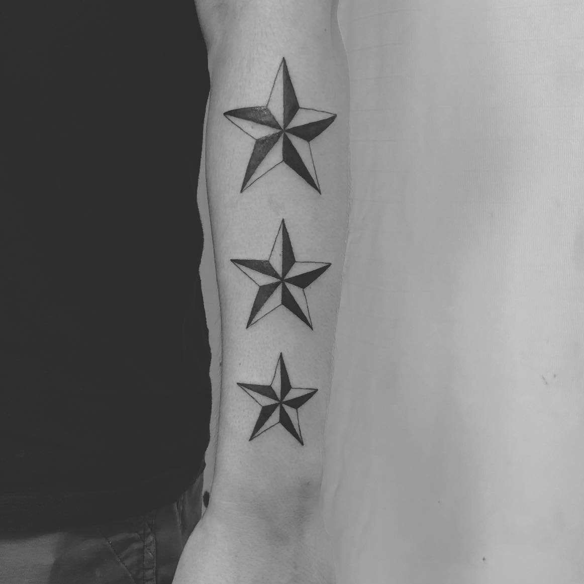 Minimalist north star tattoo in white ink