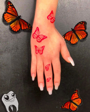 Monrach Butterfly hand tattoo red