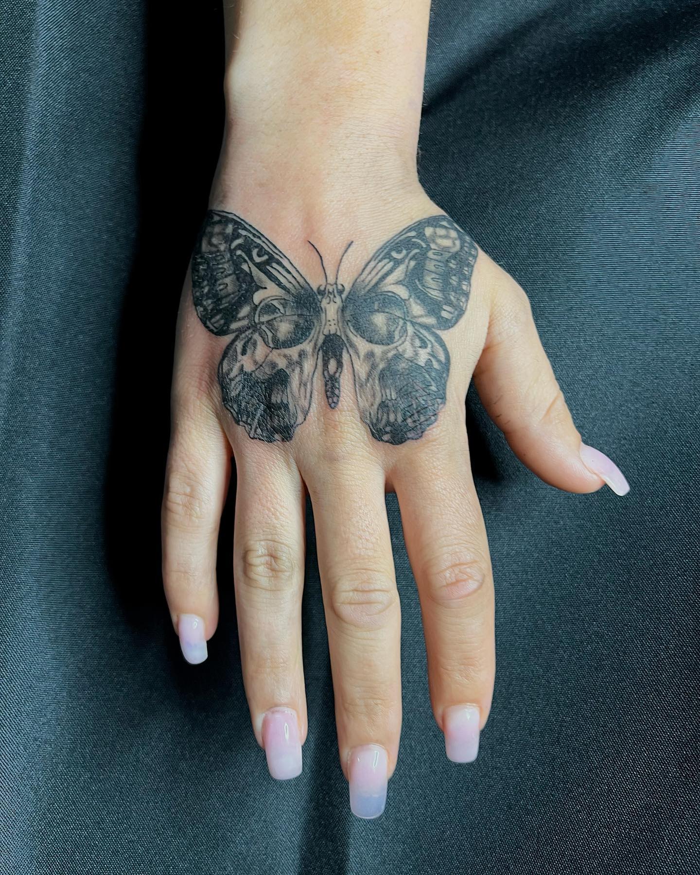 Simple Butterfly skull hand tattoo