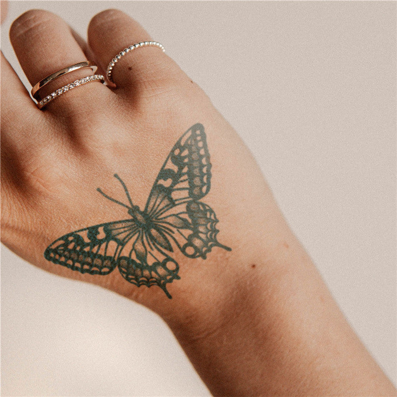 Black Butterfly Tattoo On Elbow