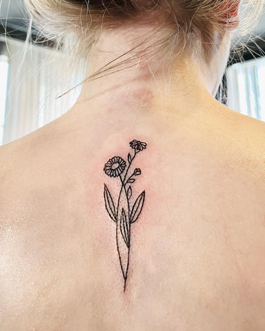 minimalist marigold tattoo