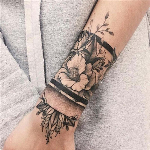Fine line roses tattooed on the inner forearm