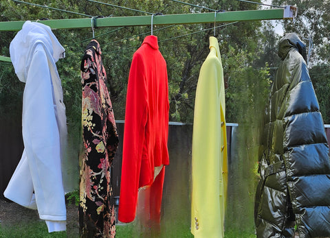 Winter coats hanging on a clothesline
